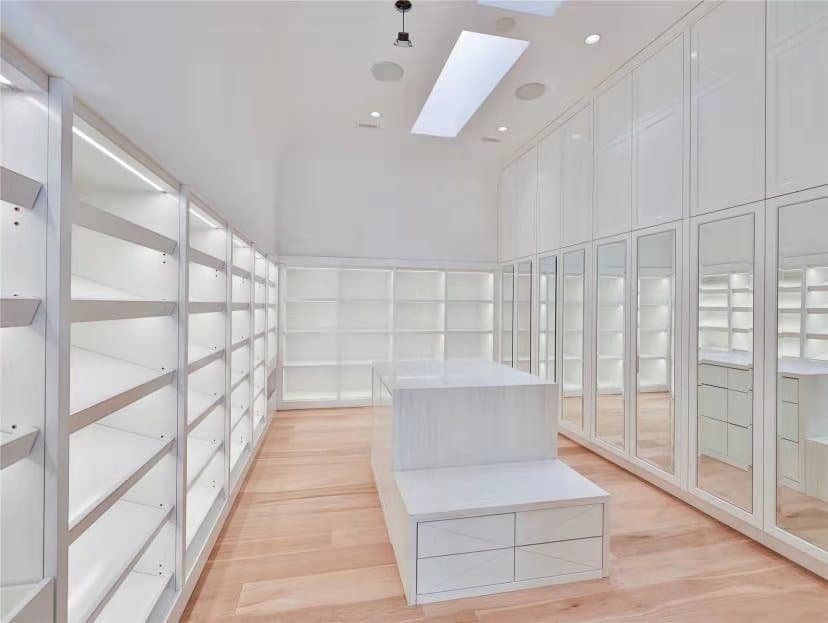 Master Walk-In White Closet with Mirrors and Island