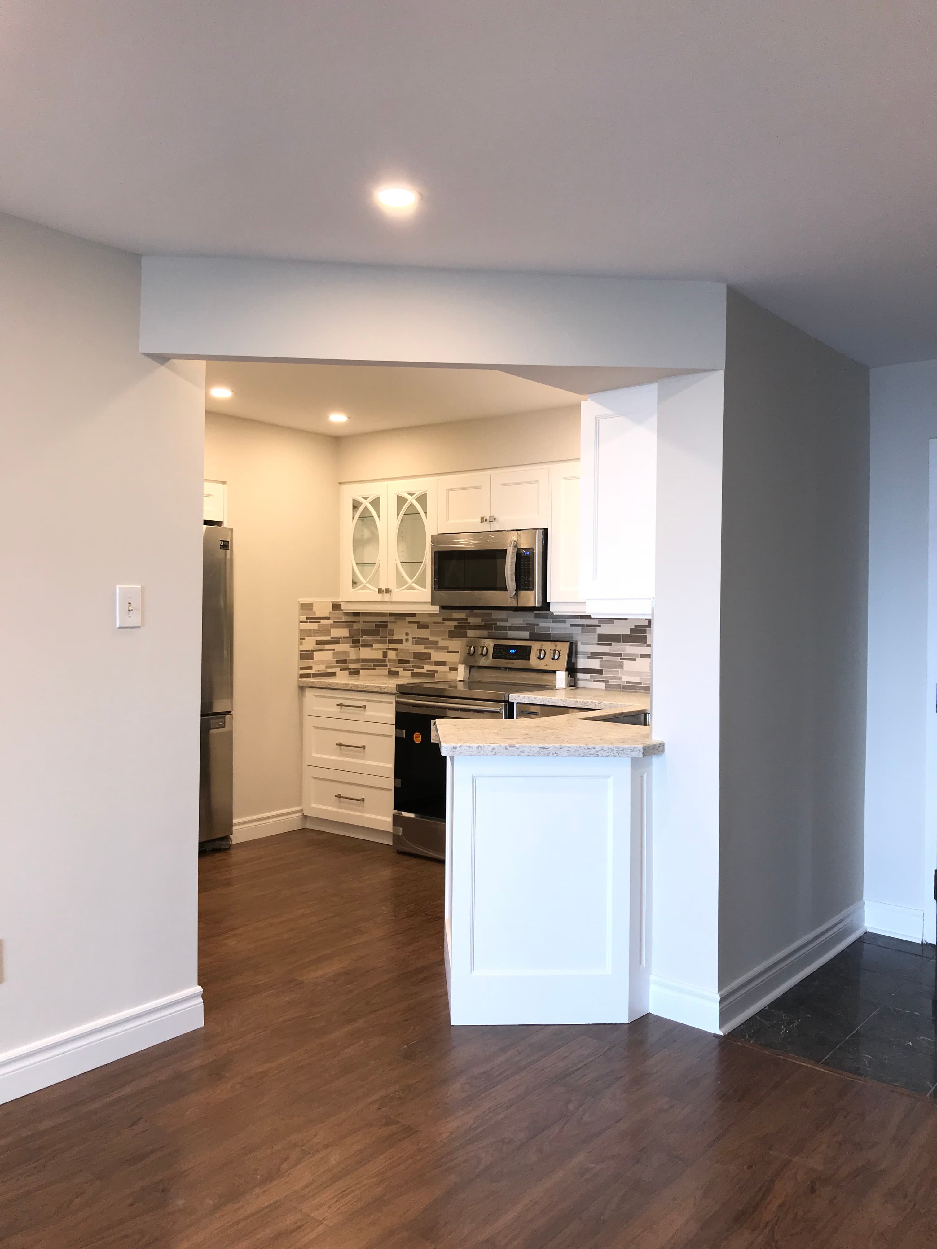 Transitional Kitchen Featuring Angled Cabinetry for Angled Wall